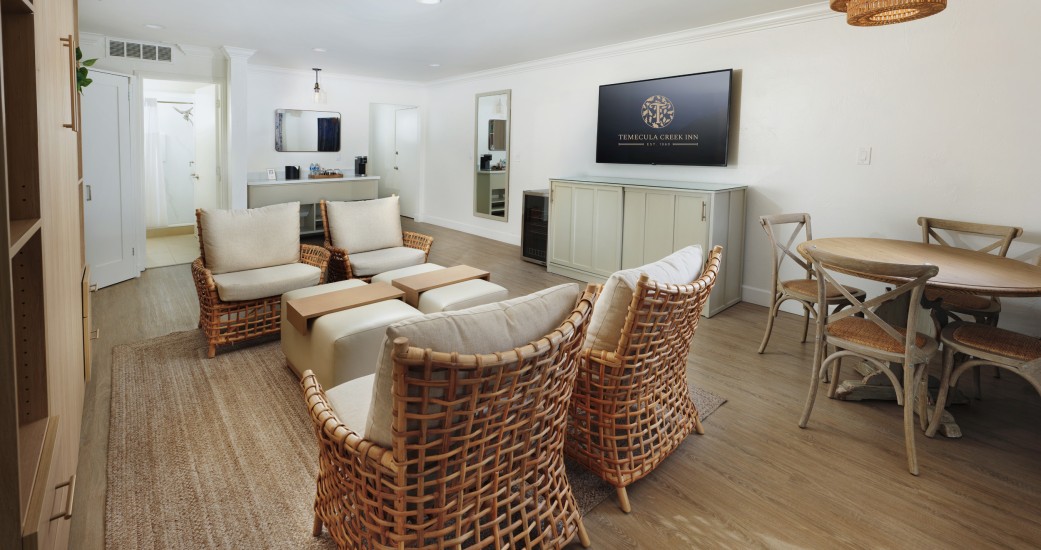 a room with wicker chairs and a television