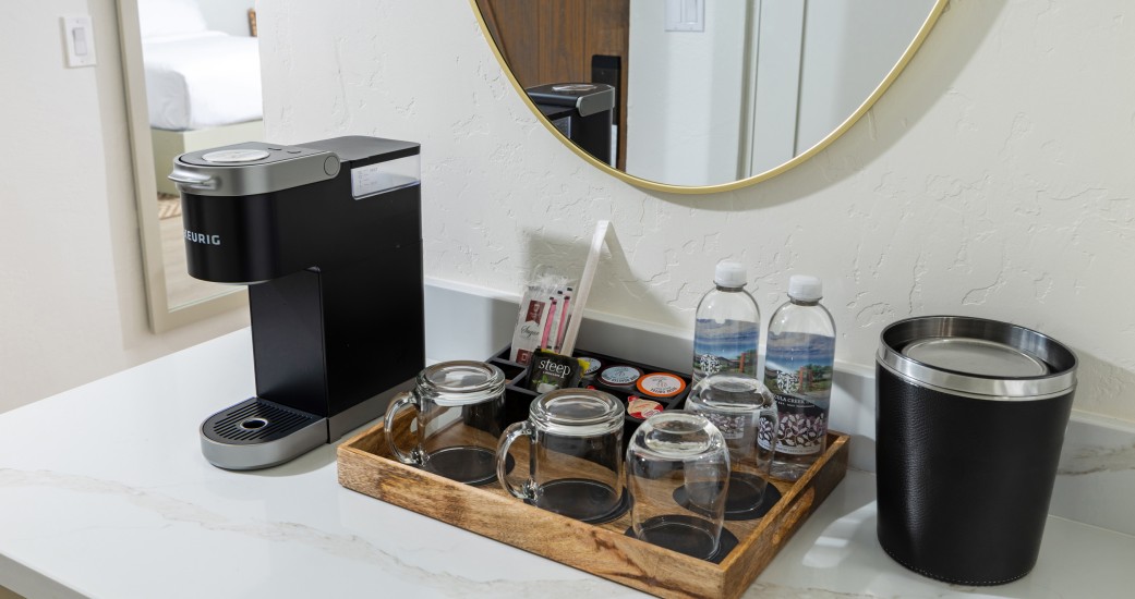 a coffee machine and cups on a counter
