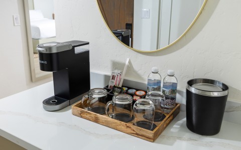 a coffee machine and cups on a counter