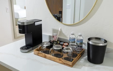 a coffee machine and cups on a counter