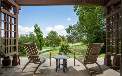 a wooden patio with chairs and a table