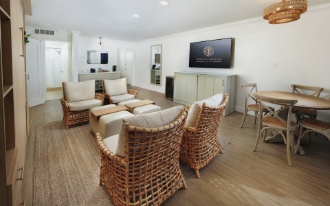 a room with wicker furniture and a television