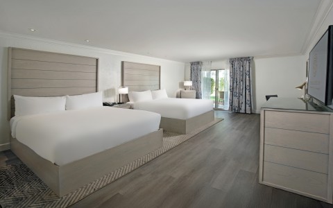 a room with two beds and a dresser
