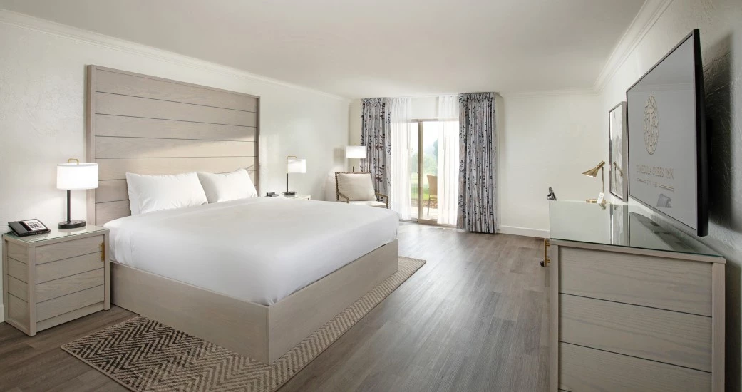 a bedroom with a large bed and a dresser
