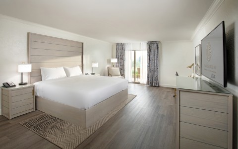 a bedroom with a large bed and a dresser