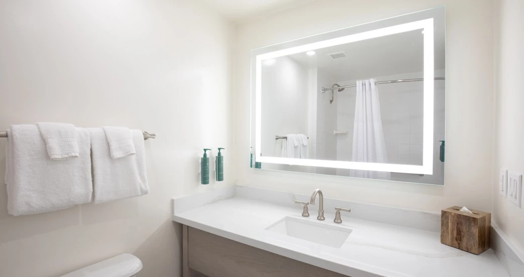 a bathroom with a mirror and a sink