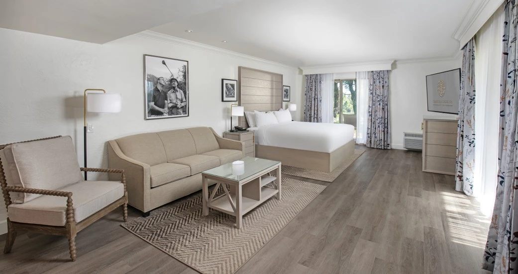 a room with a bed and a television