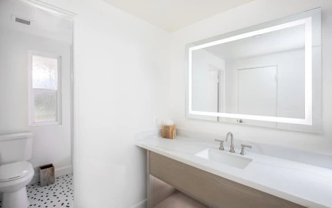 a bathroom with a mirror and sink