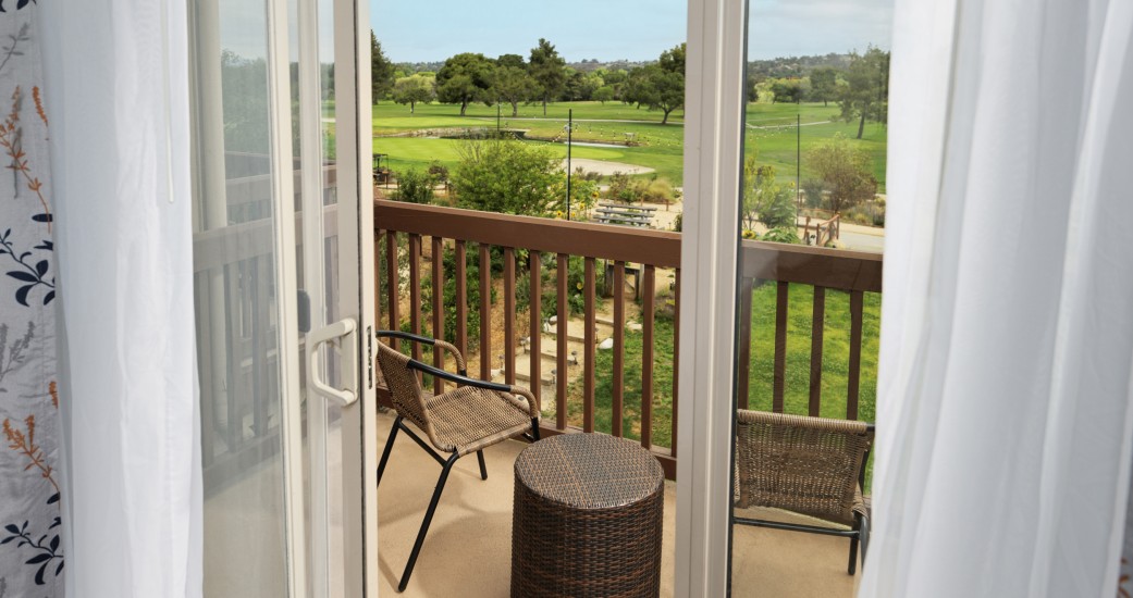 a view of a golf course from a balcony