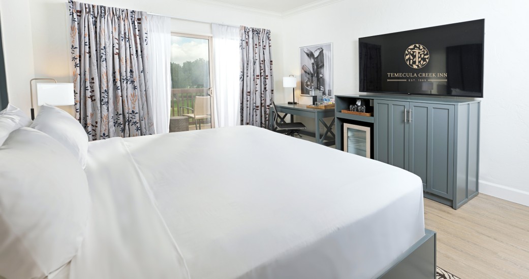 a room with a bed and a television
