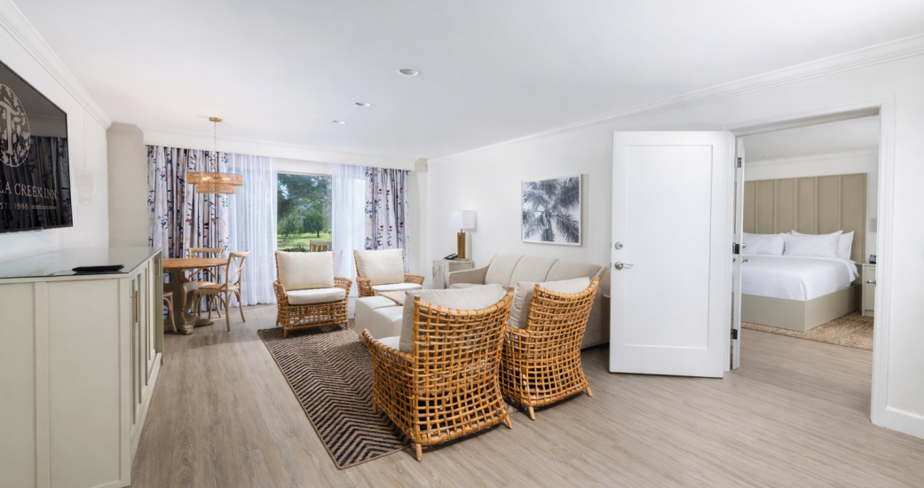 a room with a couch and chairs