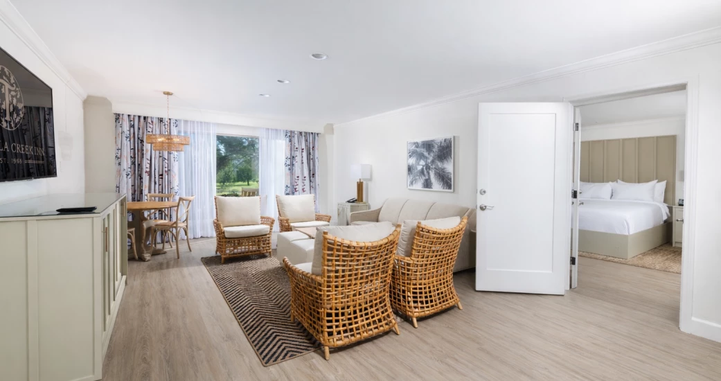 a room with a couch and chairs