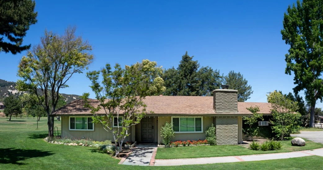 a house with a lawn and trees