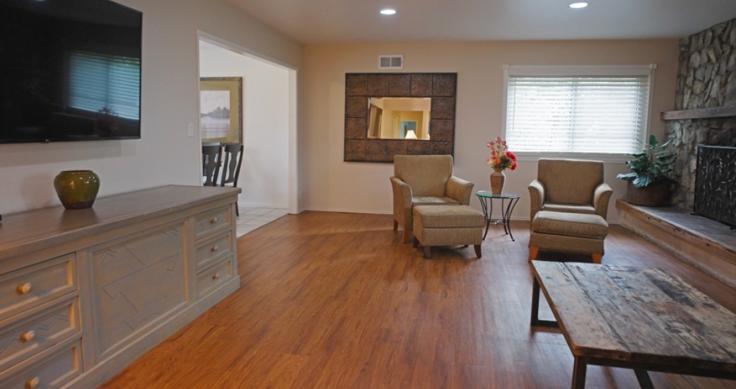 a living room with a wood floor and a wood floor