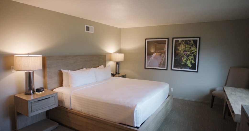 a bed with a wooden headboard and a lamp