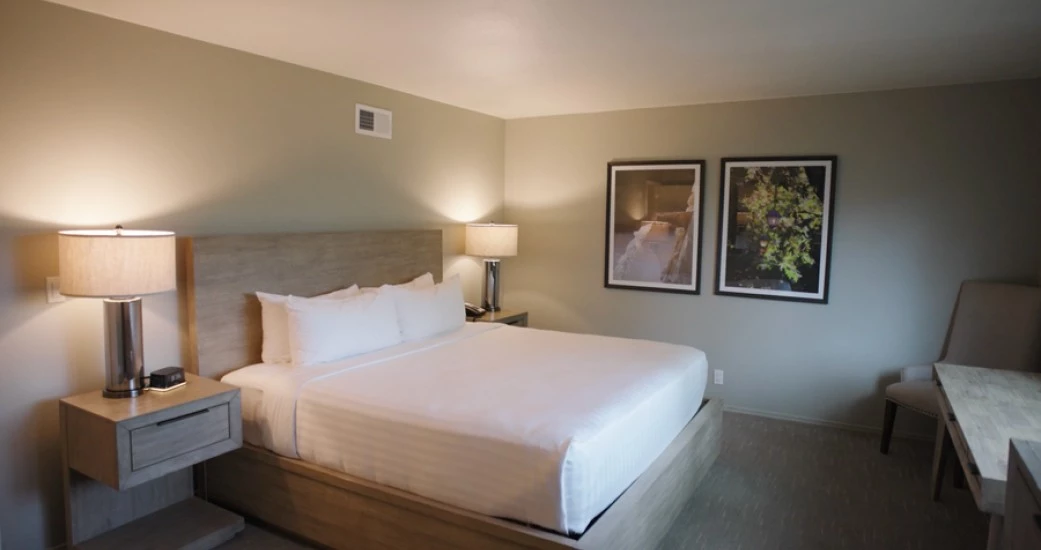 a bed with a wooden headboard and a lamp