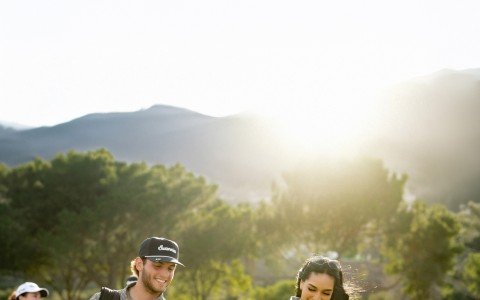 a group of people walking on a golf course