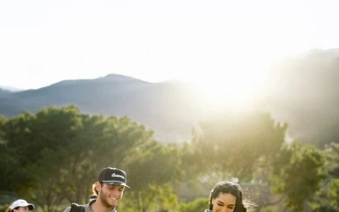 a group of people walking on a golf course