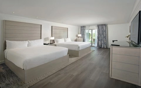 a room with two beds and a dresser