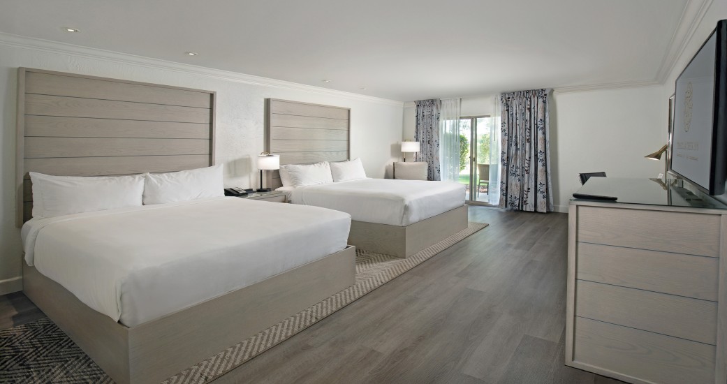 a room with two beds and a dresser