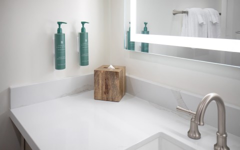 a wooden box on a counter top next to a mirror