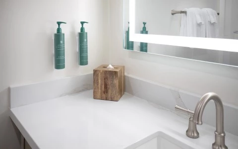 a wooden box on a counter top next to a mirror