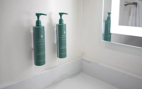 a green bottles of liquid on a wall