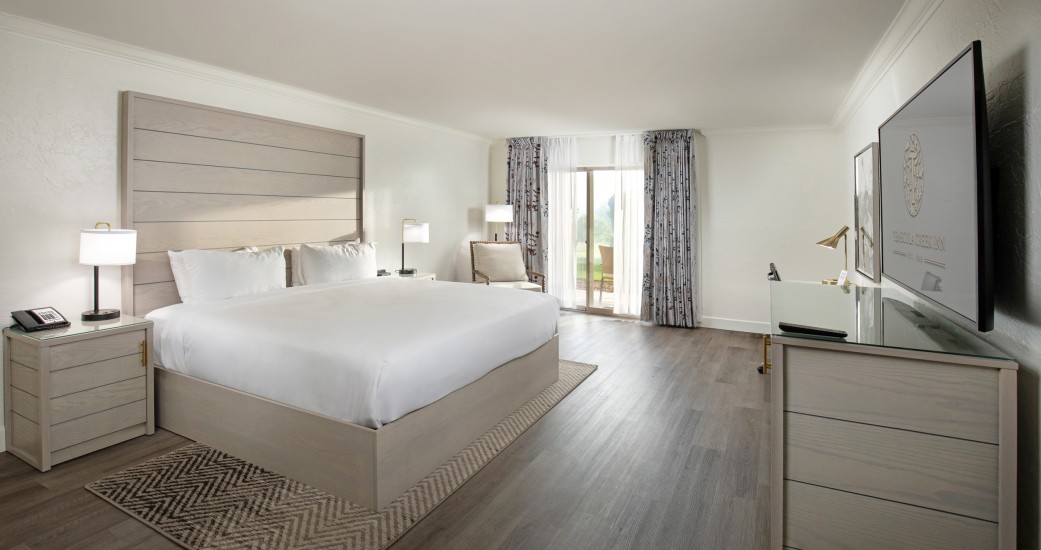 a bedroom with a large bed and a dresser