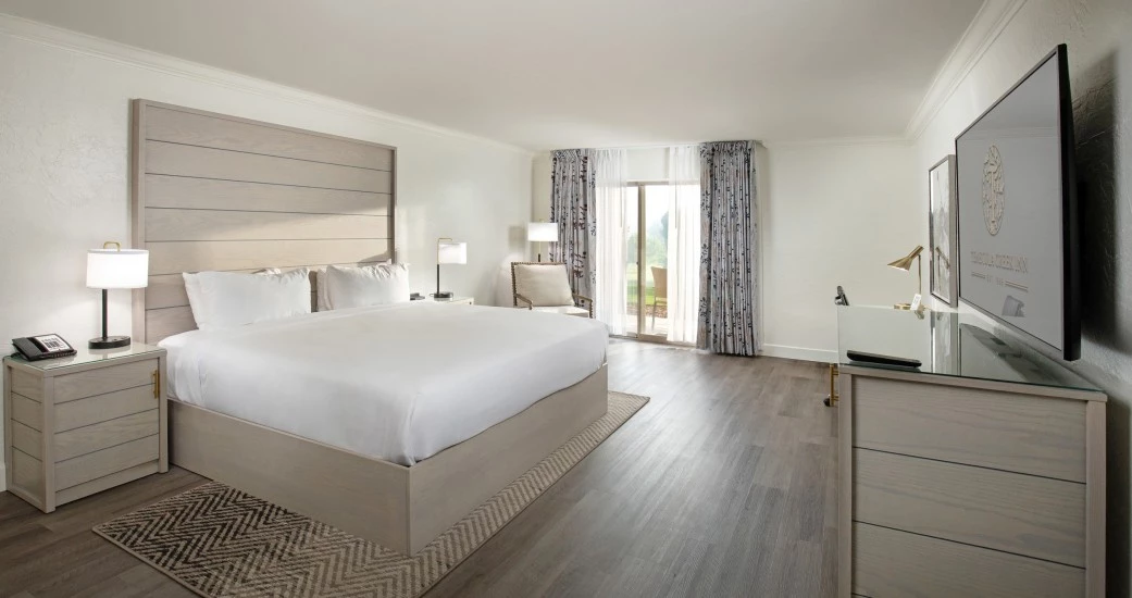 a bedroom with a large bed and a dresser