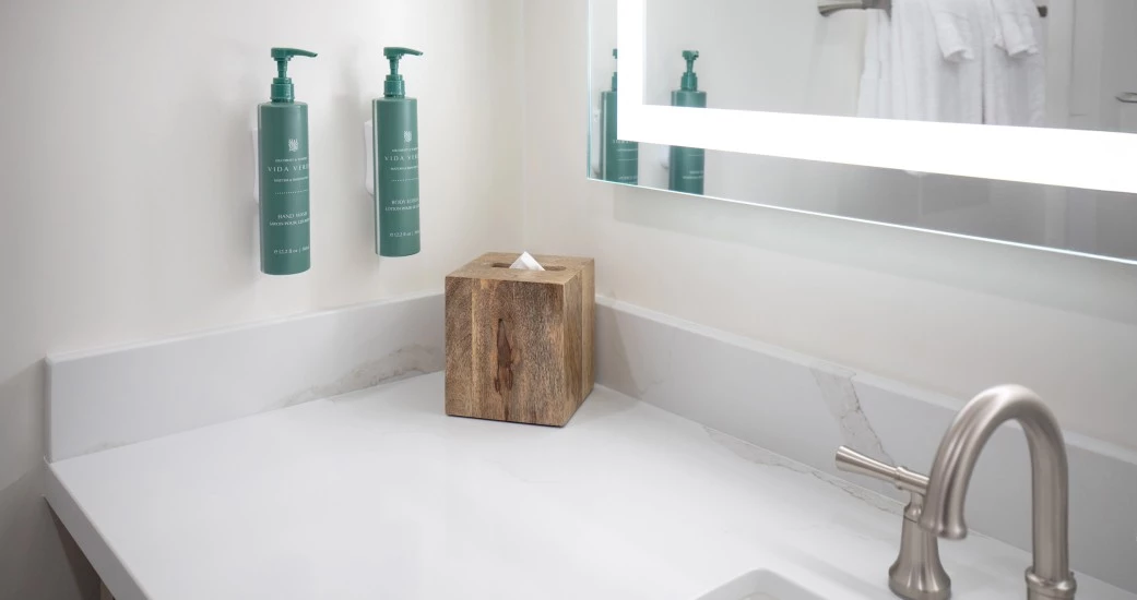 a bathroom with a mirror and a box of tissues