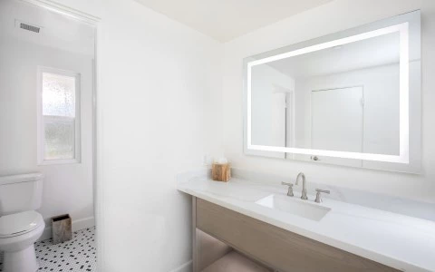 a bathroom with a mirror and sink