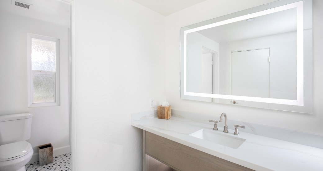 a bathroom with a mirror and sink