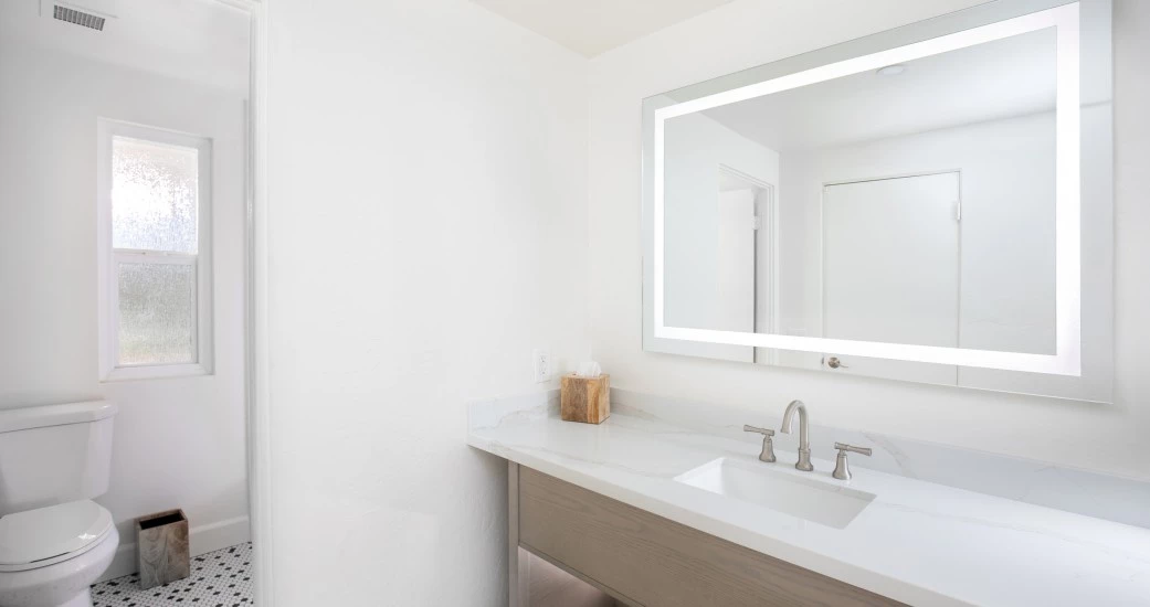 a bathroom with a mirror and sink