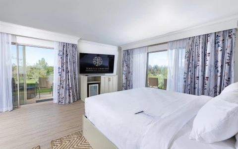 a bedroom with a television and a television set