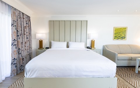 a bed with pillows and lamps in a room