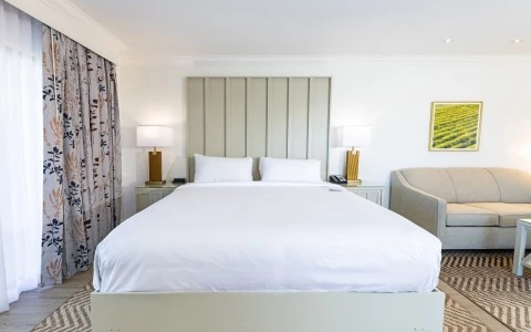 a bed with pillows and lamps in a room