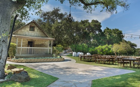 a house with tables and chairs outside