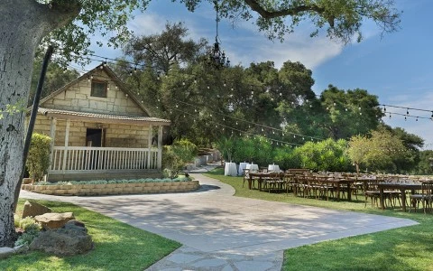 a house with tables and chairs outside