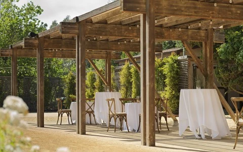 a table and chairs under a covered patio