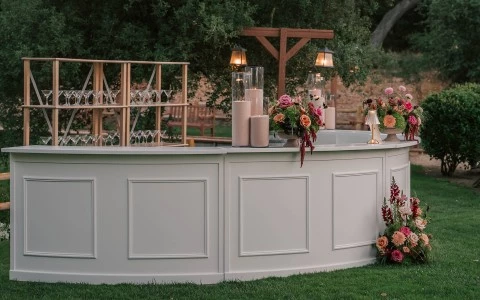 a white bar with candles and flowers