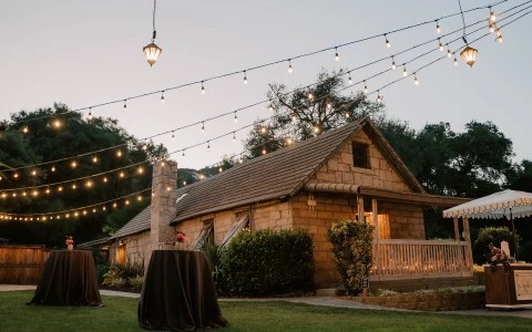 a house with a table and string of lights