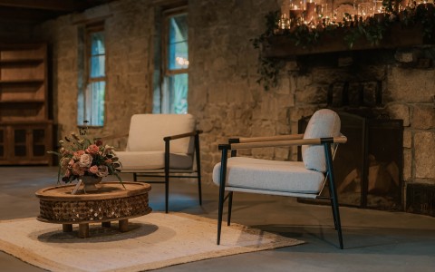 a room with a fireplace and chairs