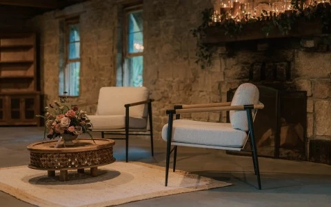 a room with a fireplace and chairs