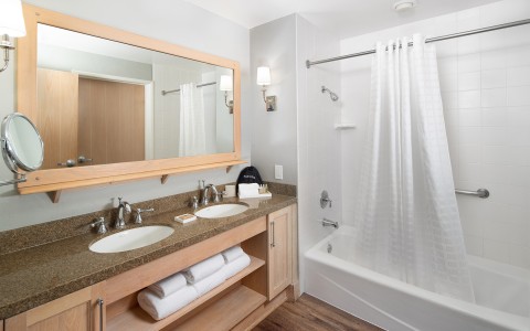 a bathroom with a mirror and a bathtub