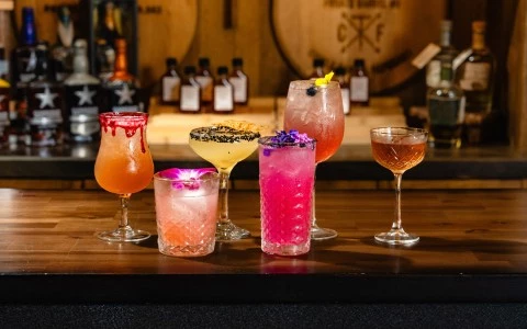 a group of different colored drinks on a table