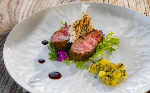a plate of food on a wood table