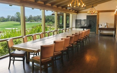 a room with a long table and chairs