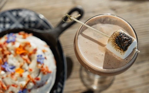 a drink with a marshmallow on a stick