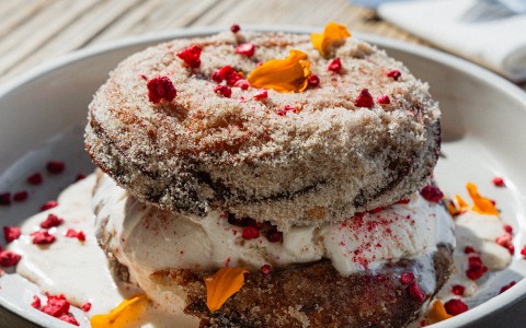 a donut with frosting and toppings on a plate