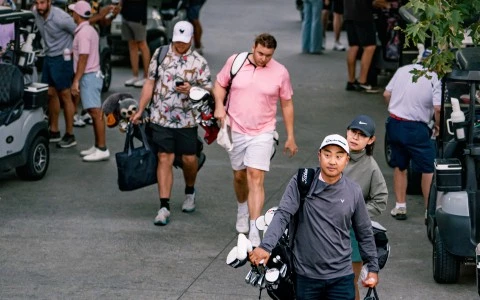 a group of people walking with golf clubs